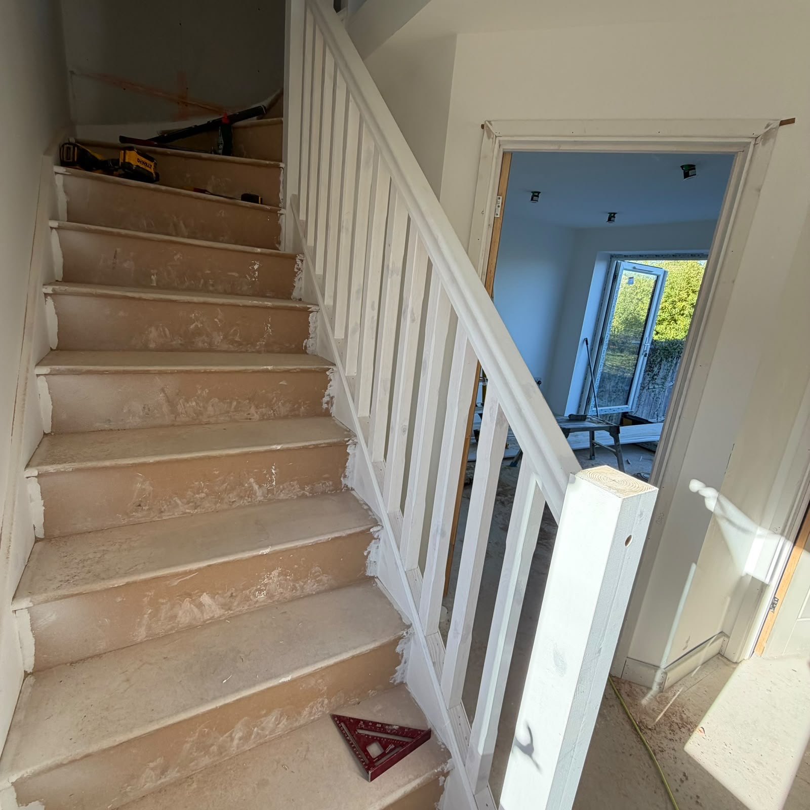 Timber staircase with white spindles and a timber handrail